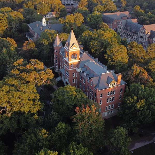 Aerial view of Main Hall and surrounding tree canopy - fall colors in the morning light